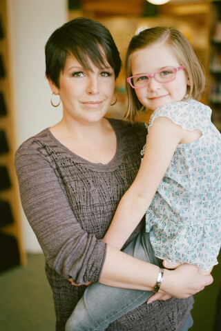 Parent holding child smiling
